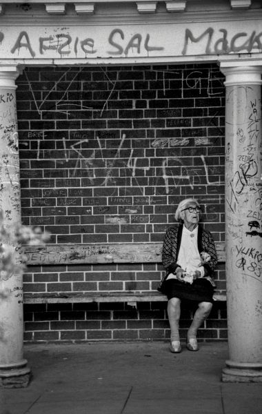 Old woman sitting in shelter, Corporation Park, Blackburn