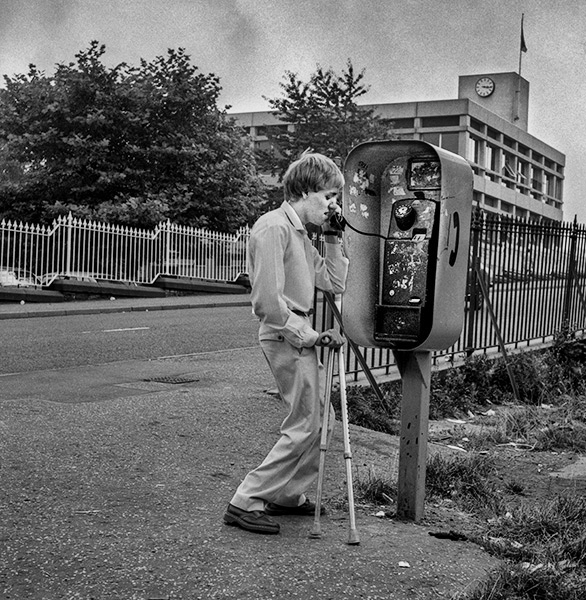 Disabled man using pay phone, Mill Hill - Blackburn - A Town and its People by Christopher John Ball