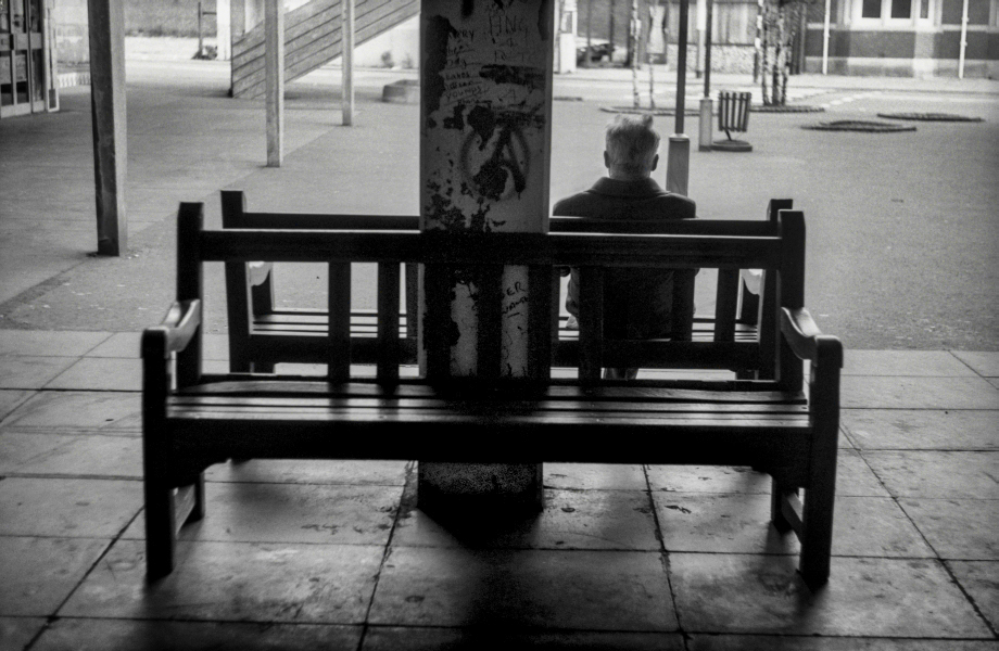 Man sat on benches by Penny Street - Blackburn a Town and Its People