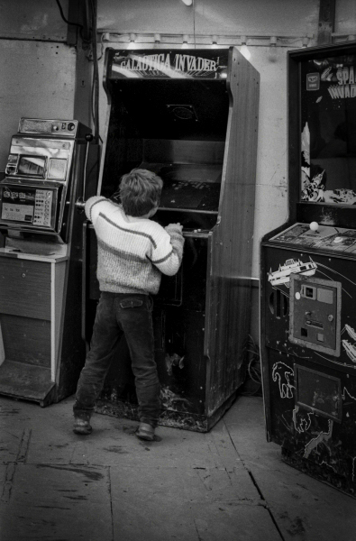 Child Playing Space Invaders At The Easter Fair - Blackburn a Town and its People Photographic Study