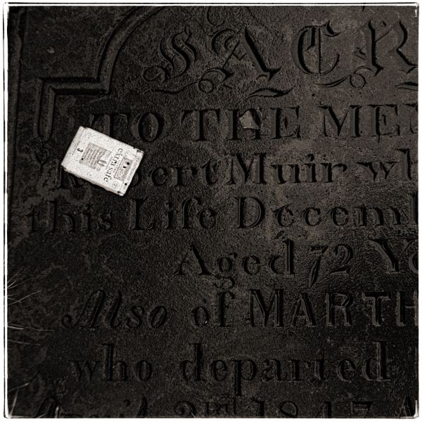 Condom Packet on Grave from Discarded: Photographic Essay by Christopher John Ball - Photographer & Writer